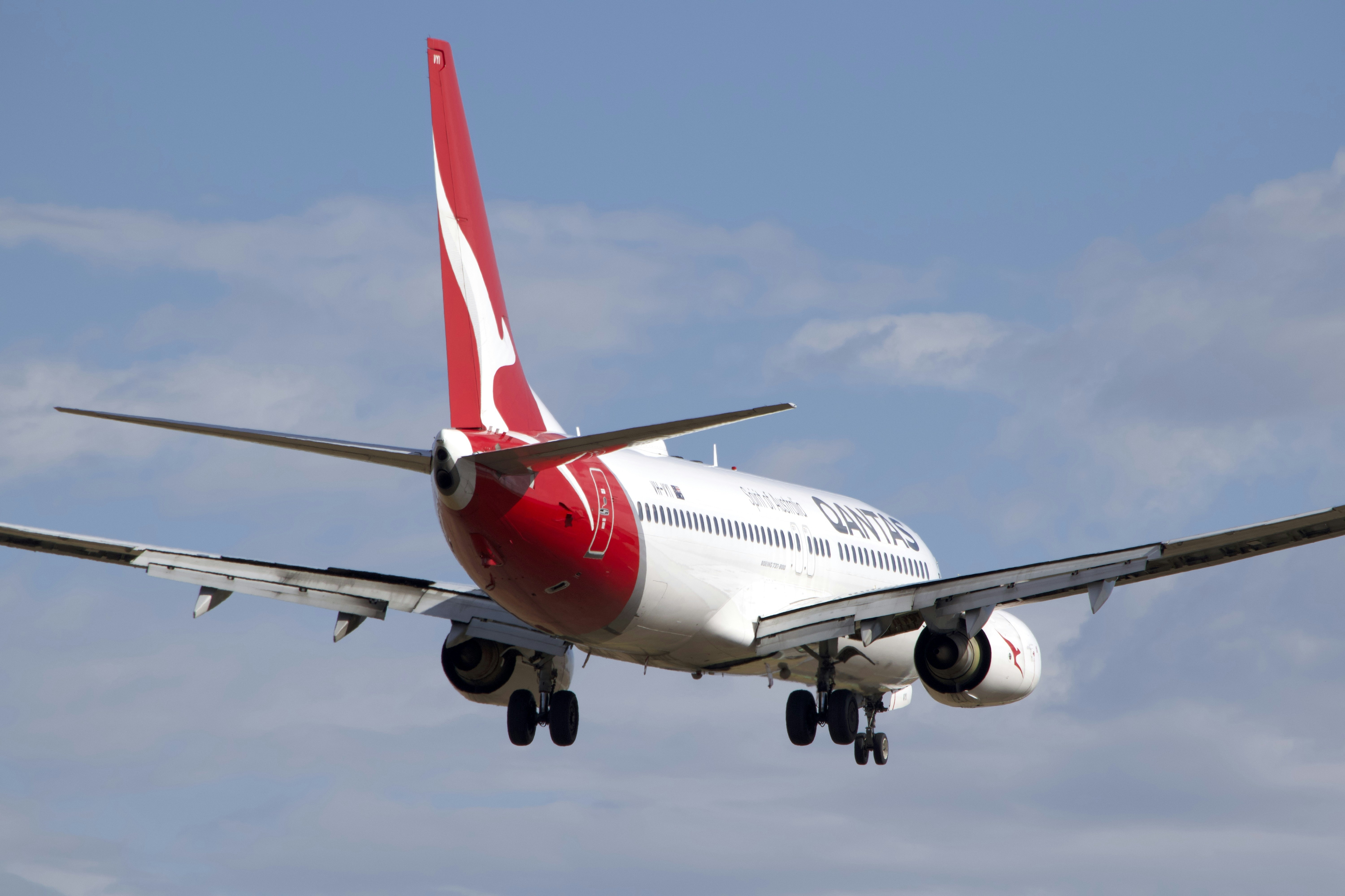 A large jetliner flying through a blue sky
