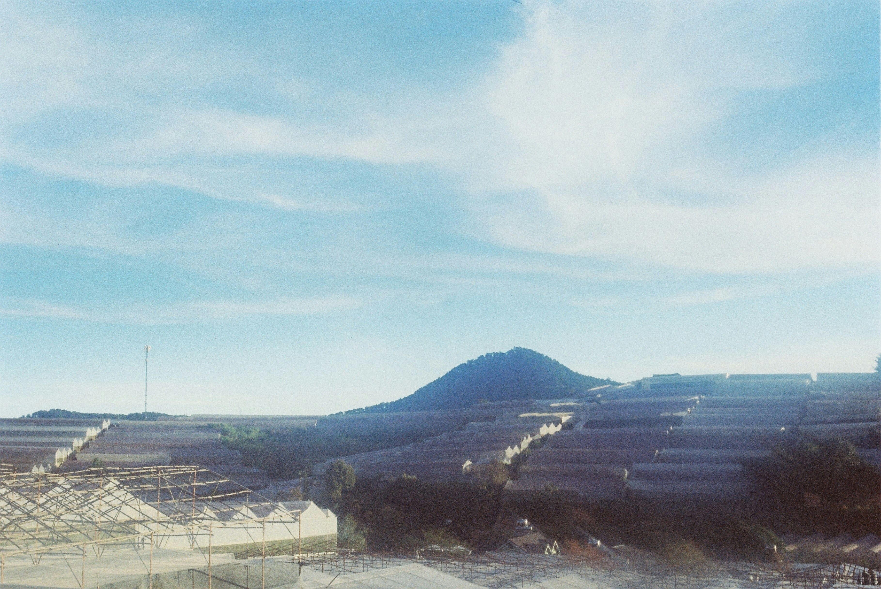 A blurry photo of a building with mountains in the background