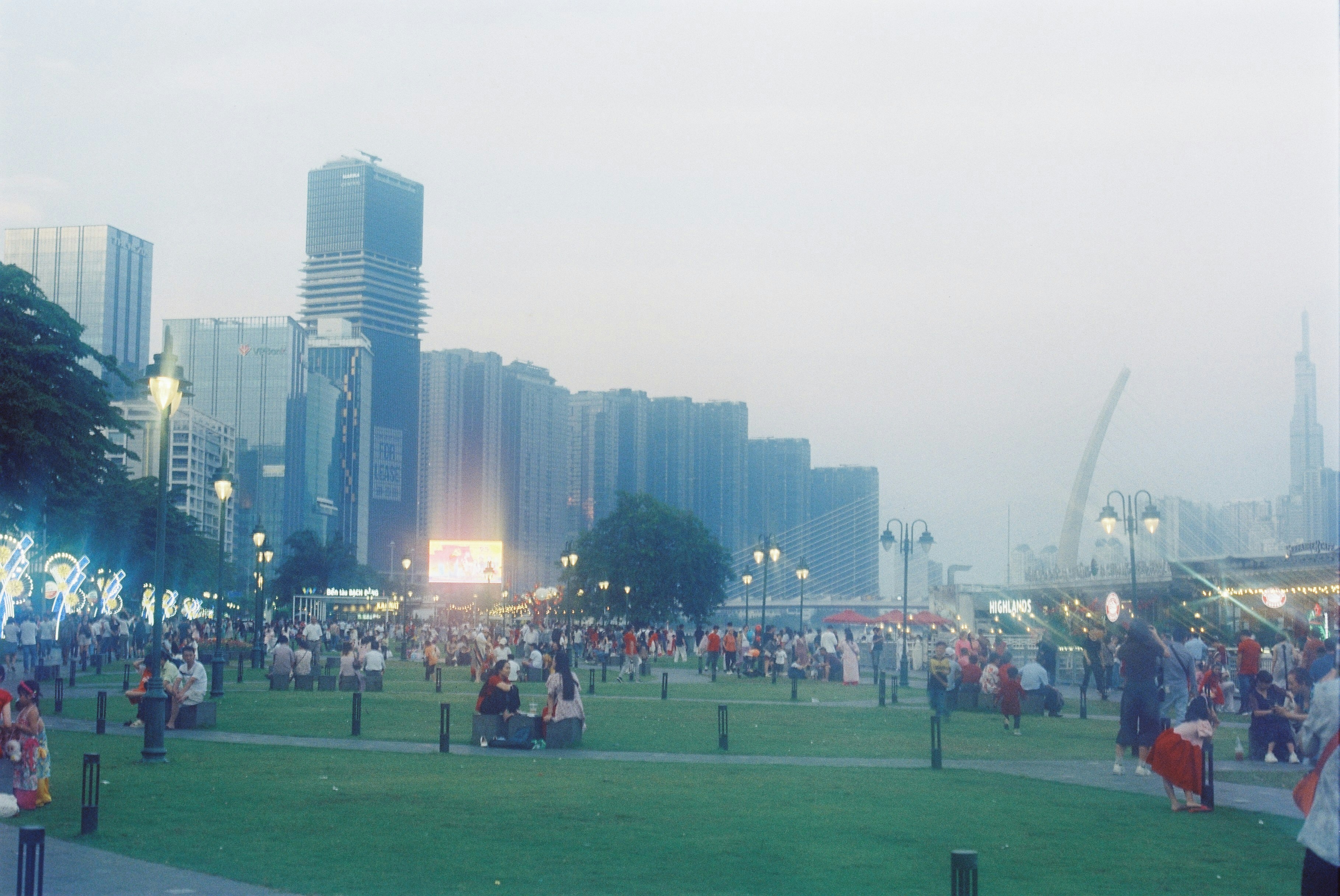 A crowd of people standing on top of a lush green field