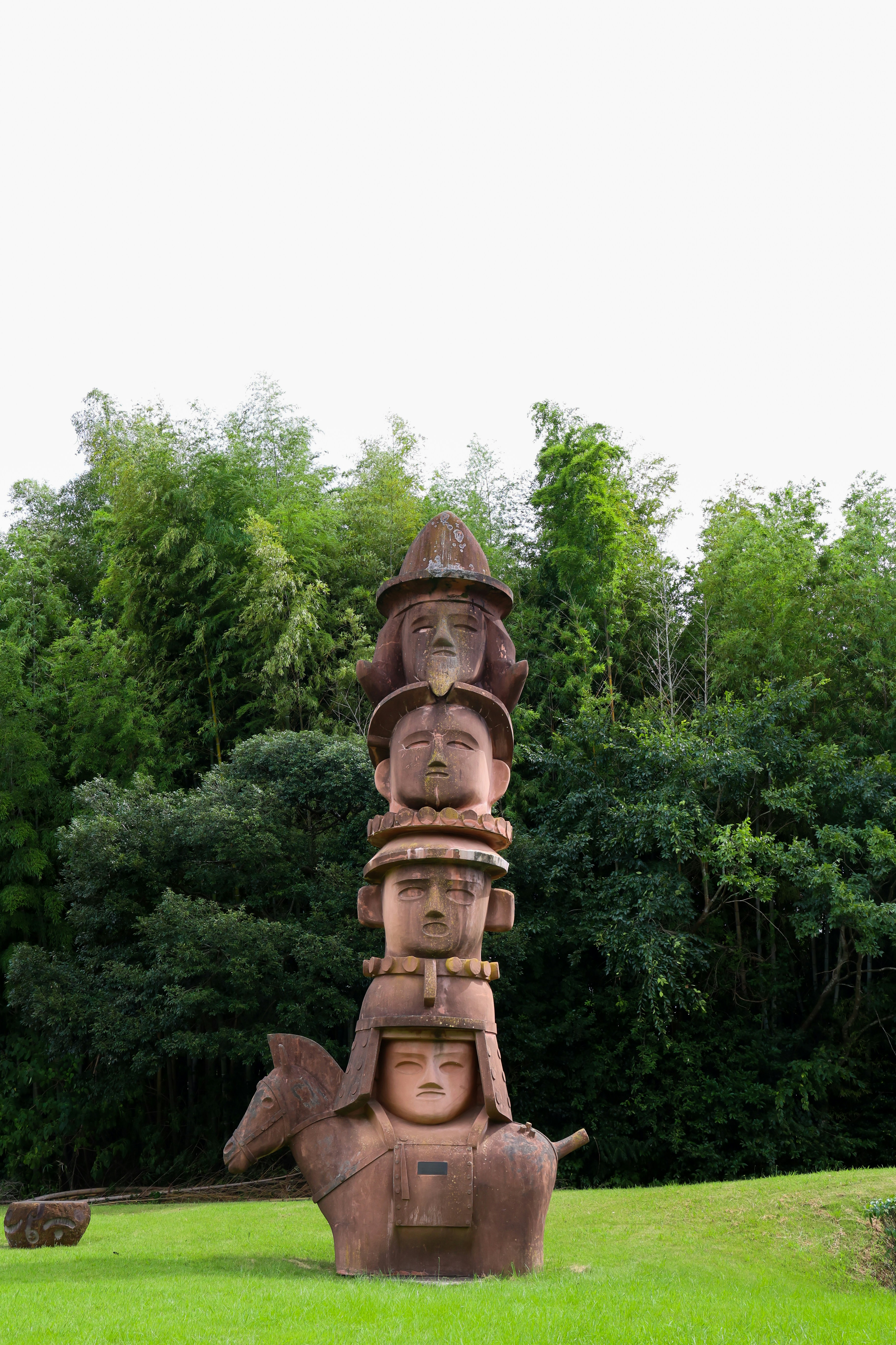 A large wooden sculpture in the middle of a field