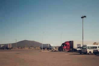 A parking lot with several trucks parked in it