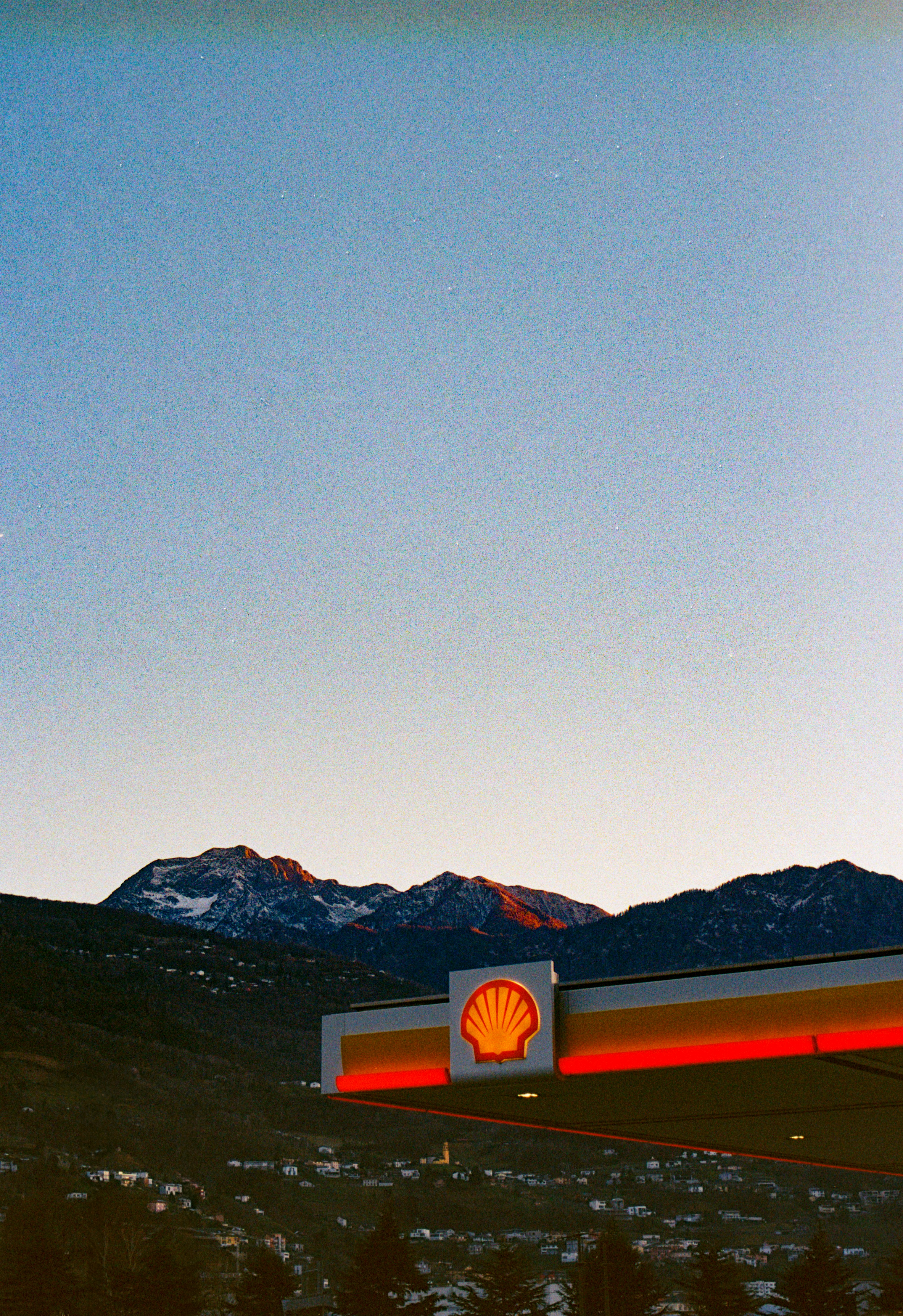 A shell gas station with mountains in the background photo – Free ...