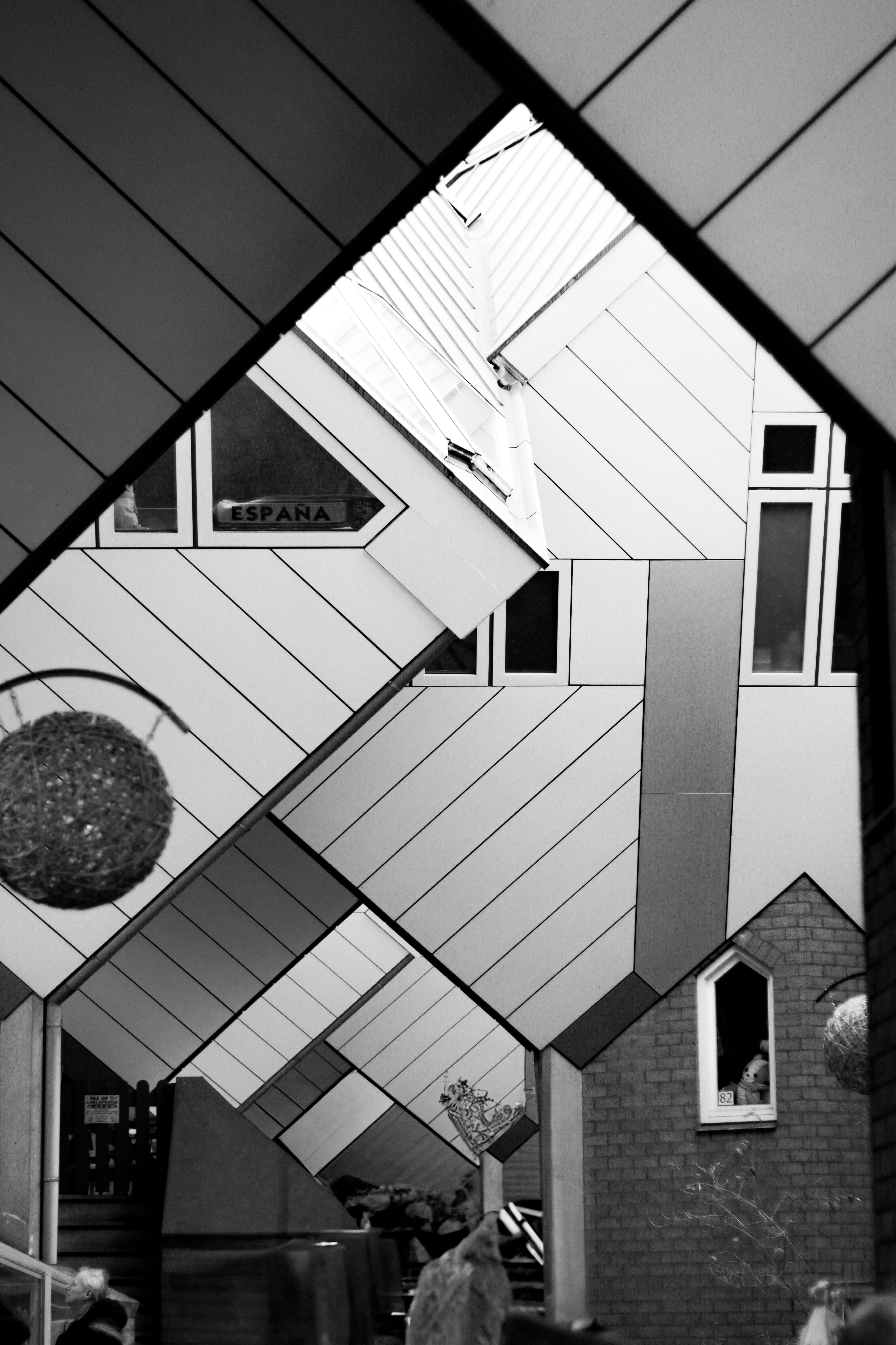 A black and white photo of people walking under a building