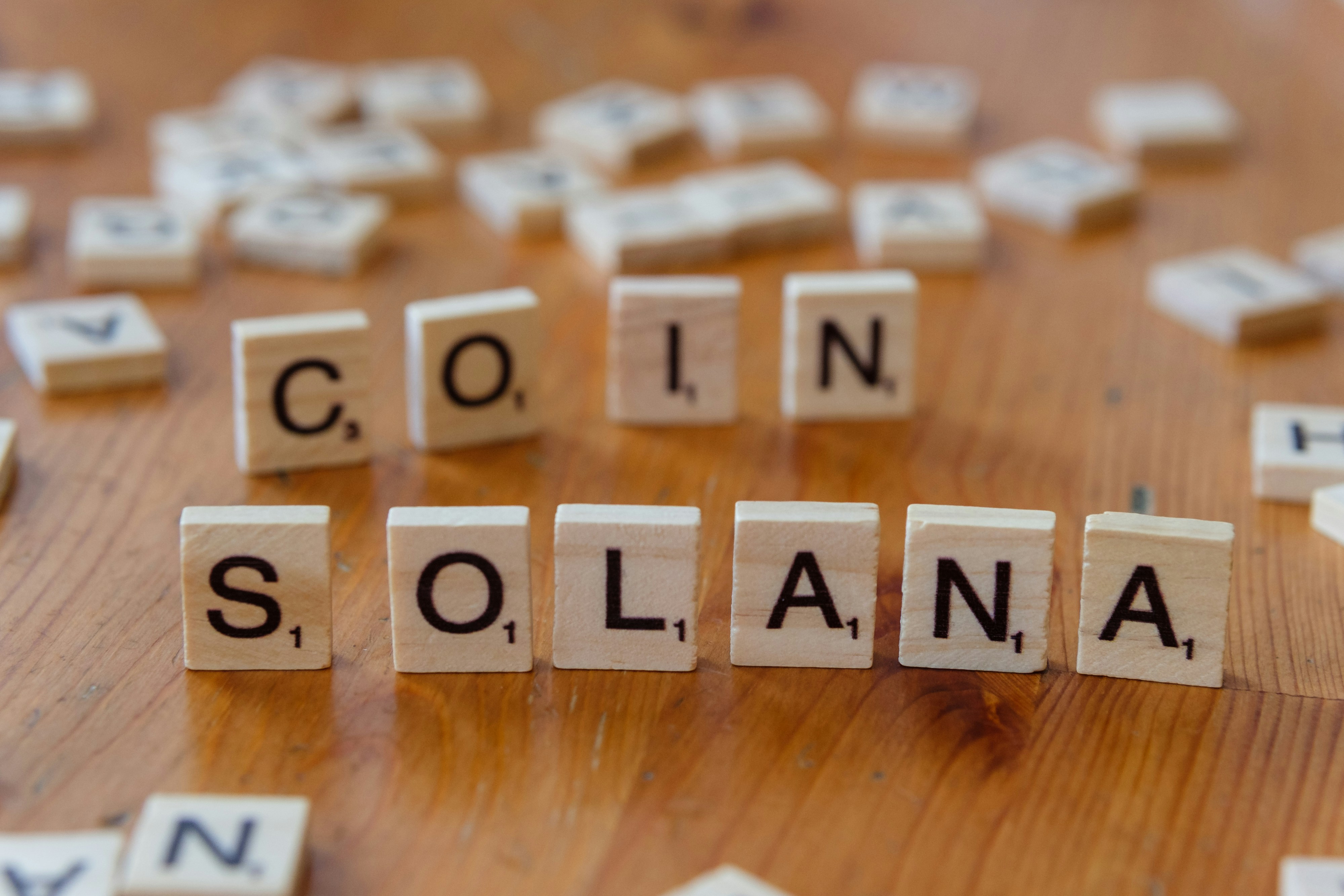 Scrabbled scrabble tiles spelling the word colina, on a