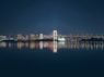 A large body of water with a bridge in the background