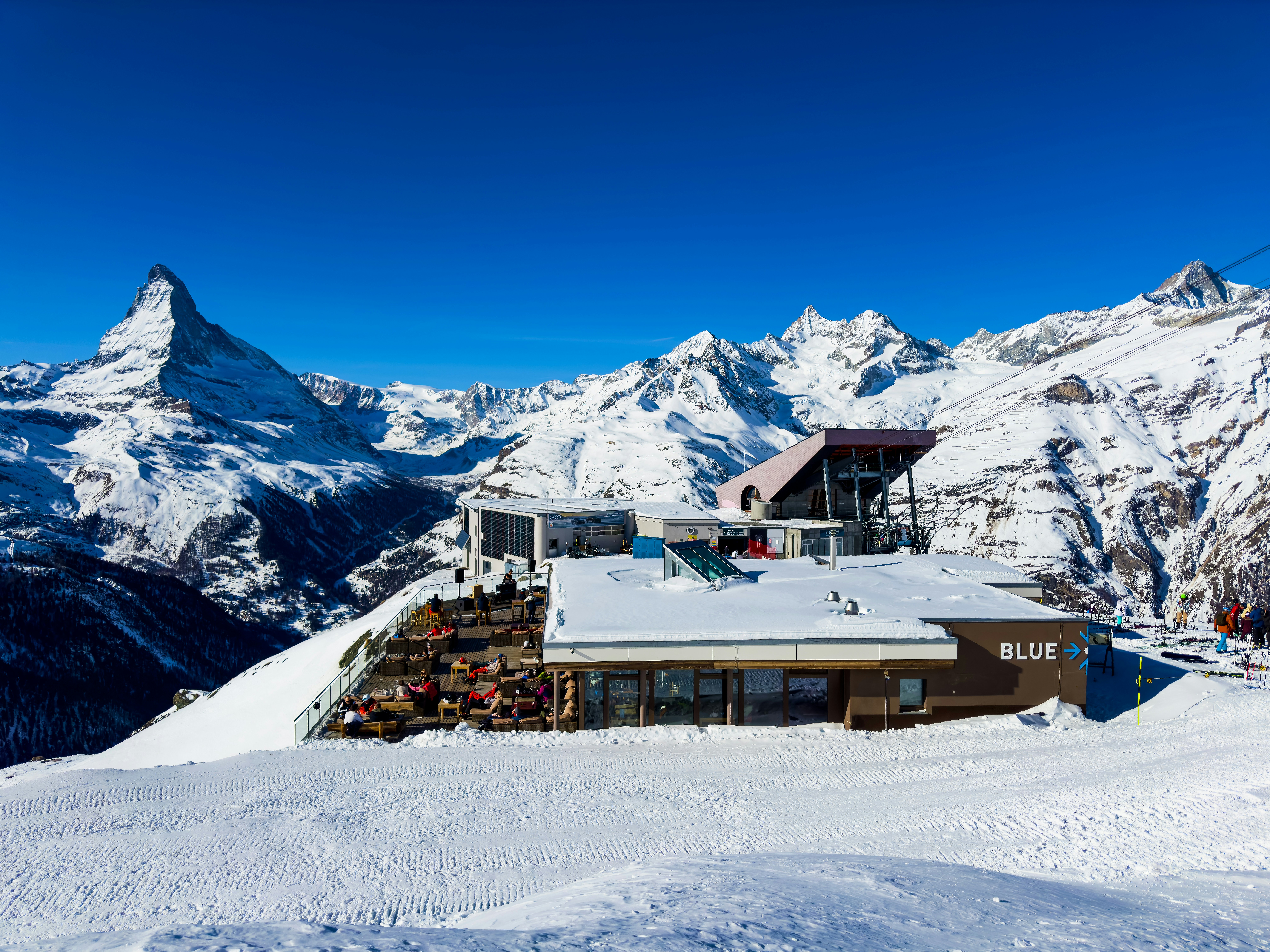 A snow covered mountain with a house on top of it