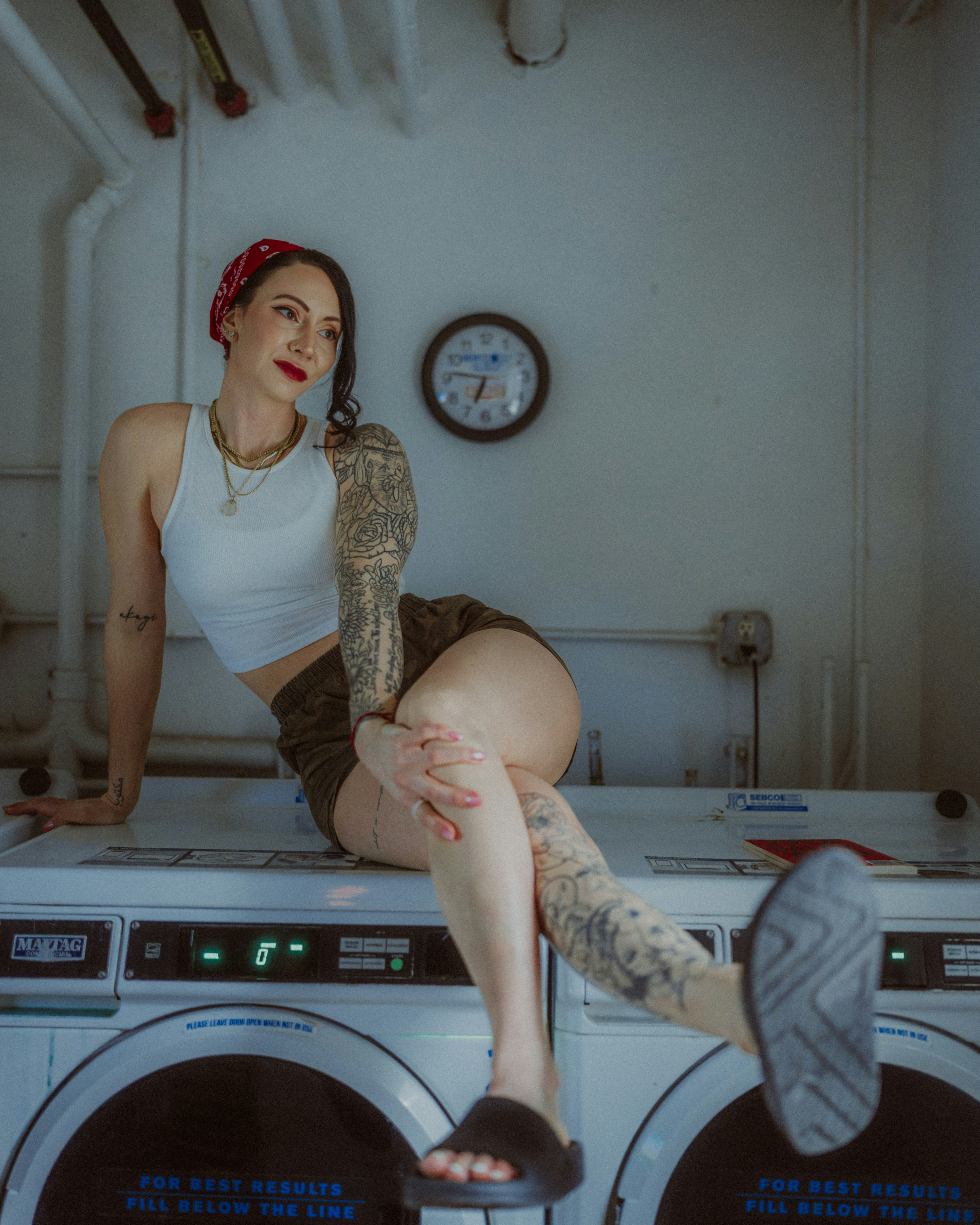 A woman sitting on top of a washing machine