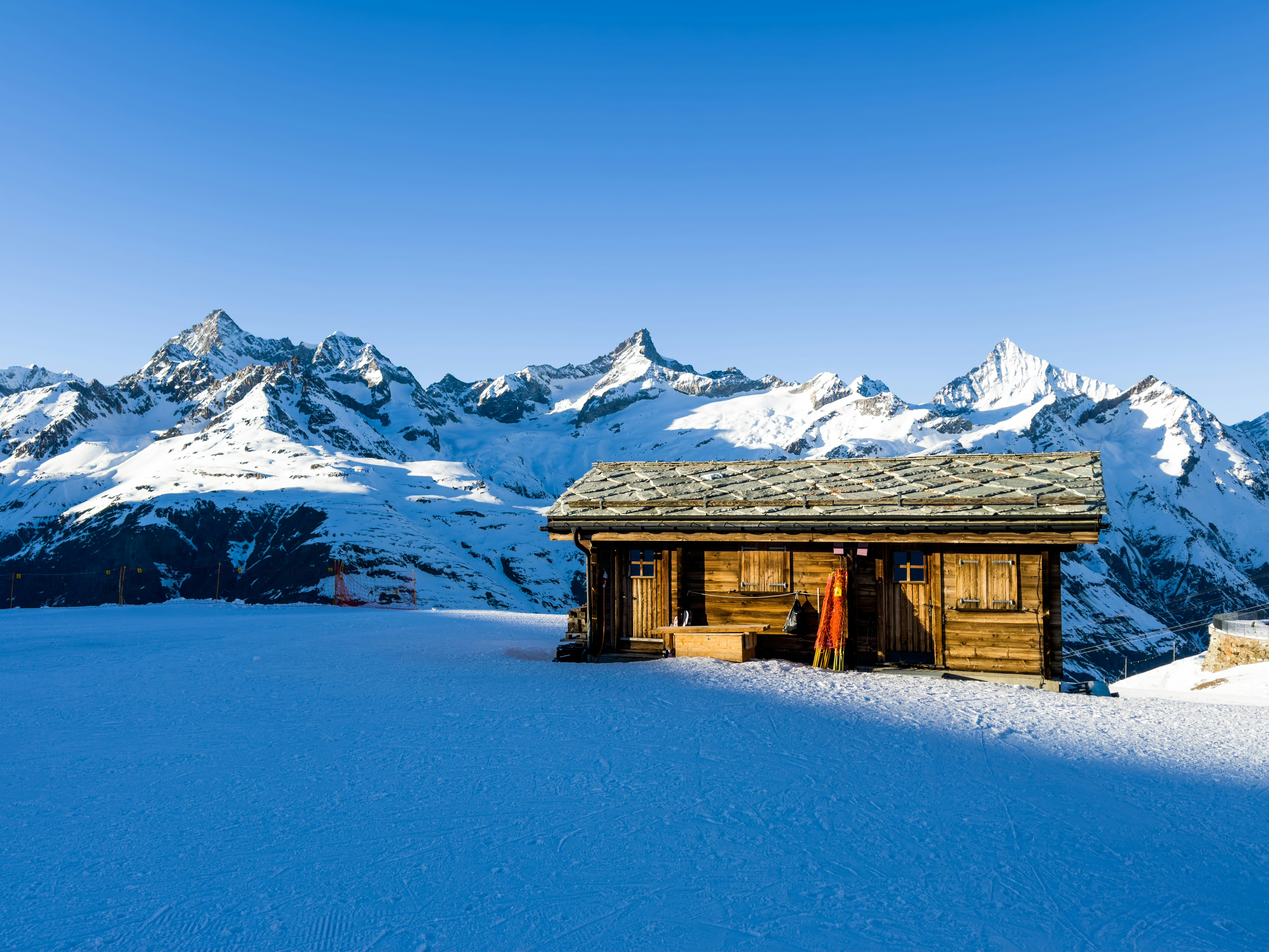 A cabin in the middle of a snowy mountain range