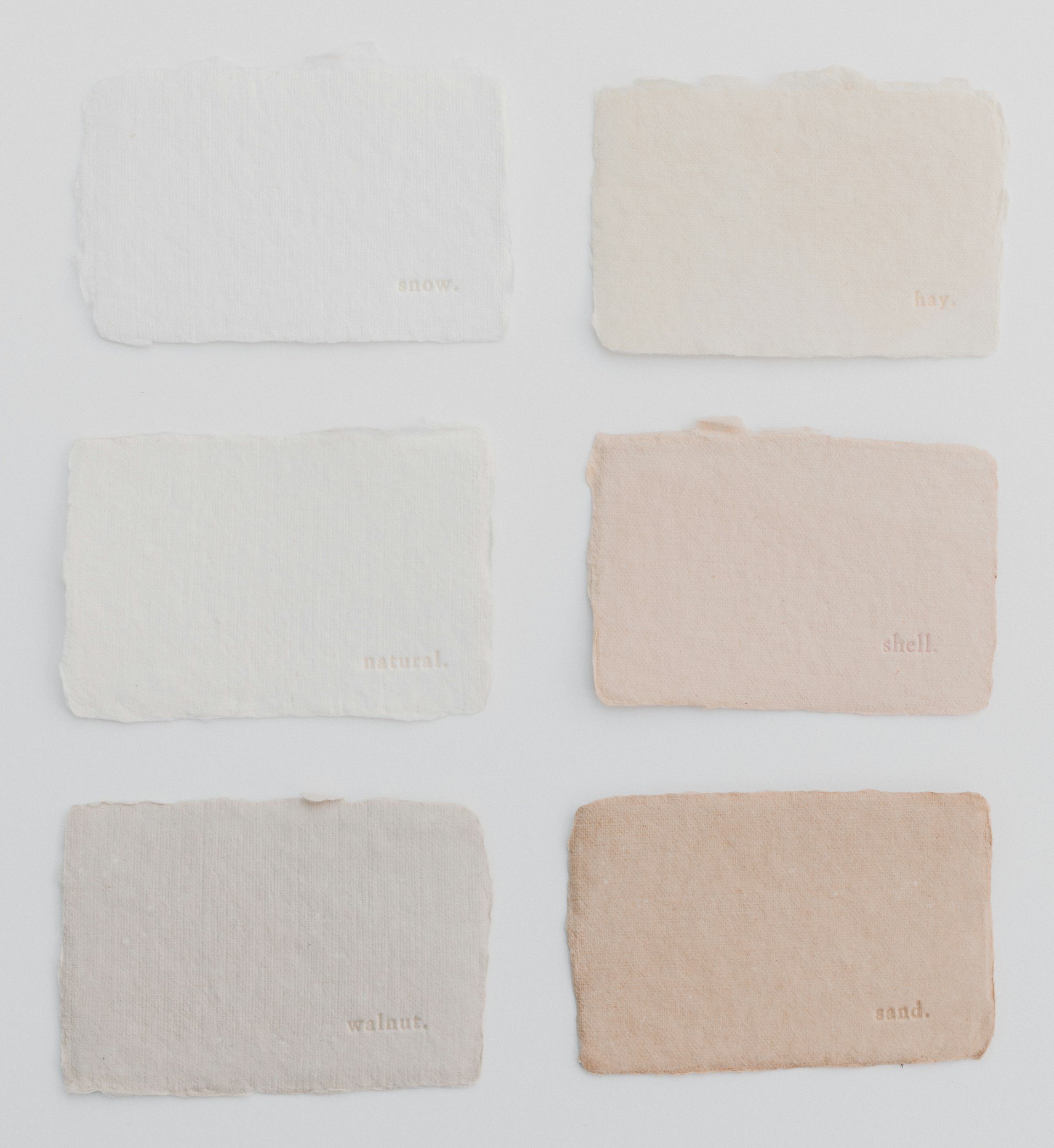 Six different shades of paint on a white surface