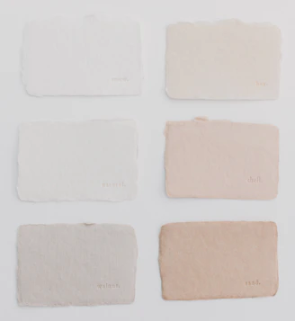Six different shades of paint on a white surface
