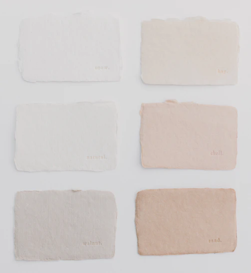 Six different shades of paint on a white surface