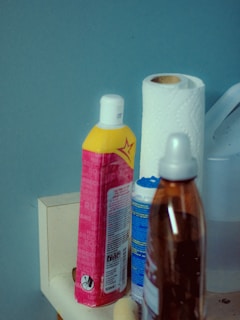 A bathroom counter with toiletries and hand sanitizers on it