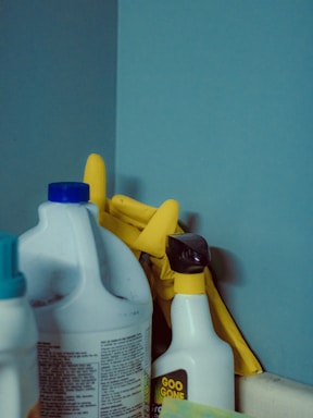 A close up of a bottle of cleaner next to a mirror