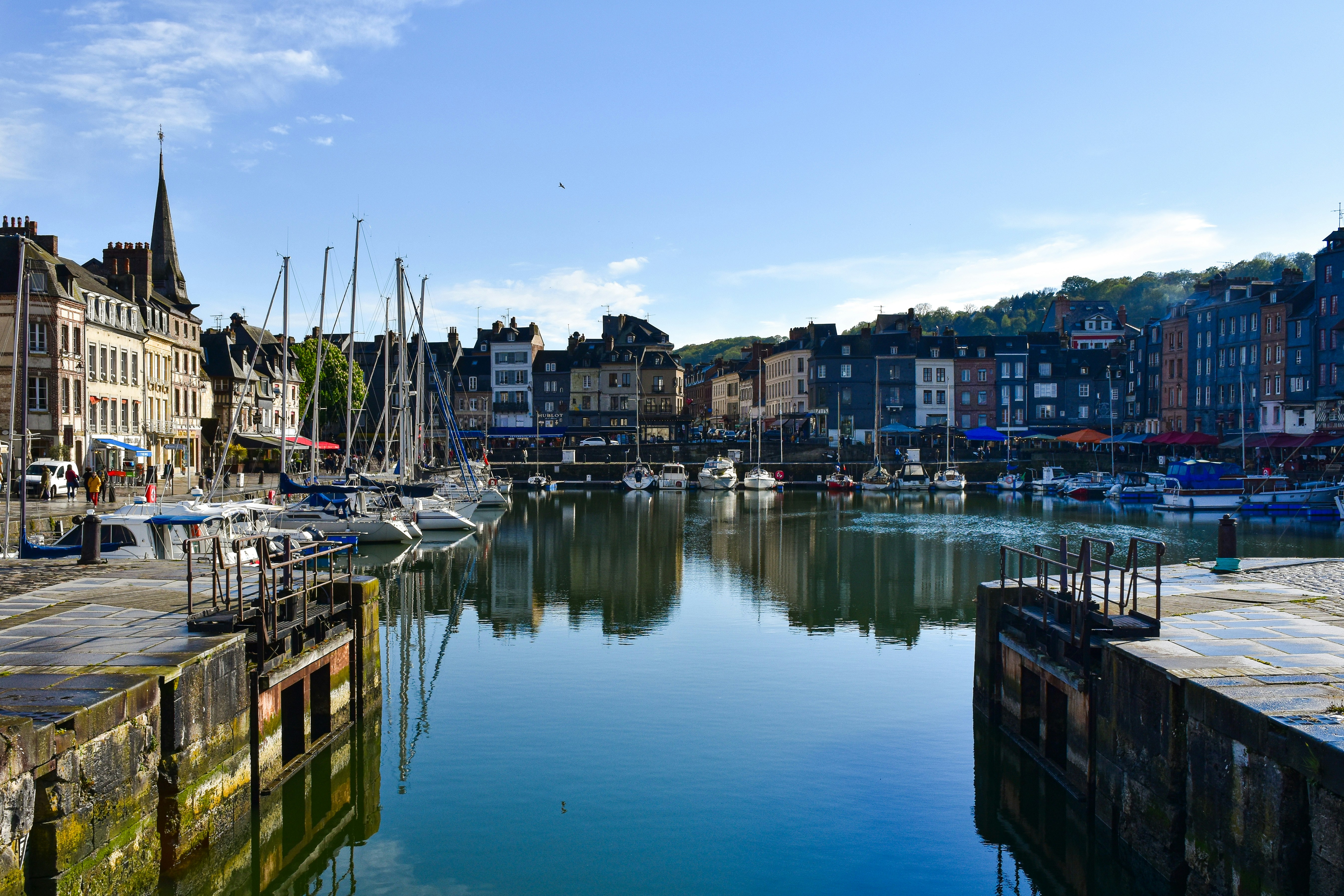 A harbor filled with lots of boats next to tall buildings