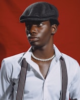 A man wearing a hat and suspenders