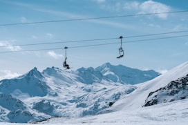 A snow covered mountain with a ski lift in the background