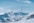A snow covered mountain with a ski lift in the background