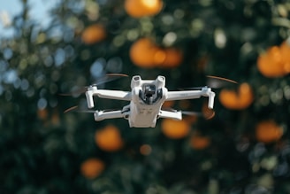 A close up of a white and black remote control flying in front of an orange