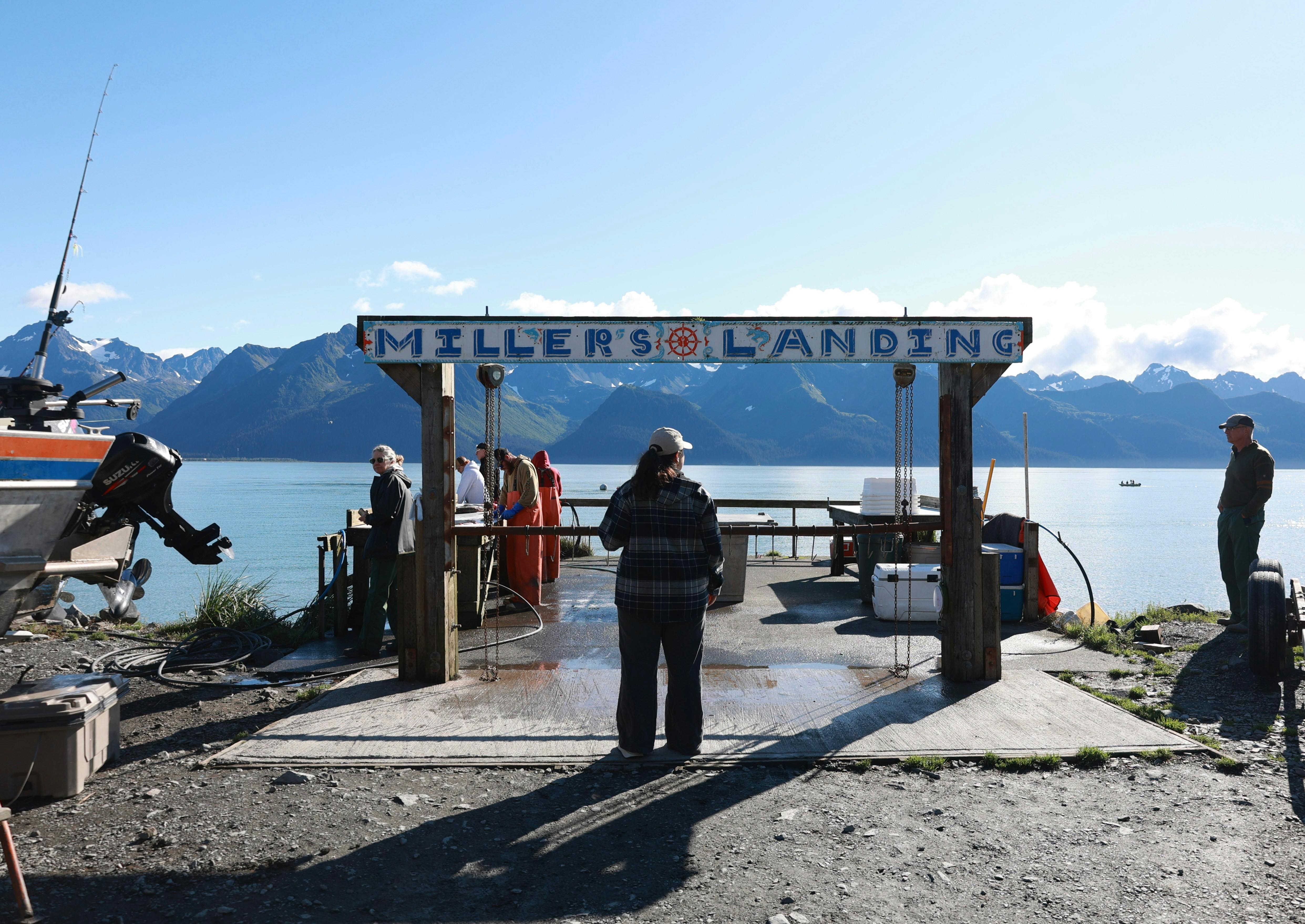 A group of people standing next to a boat