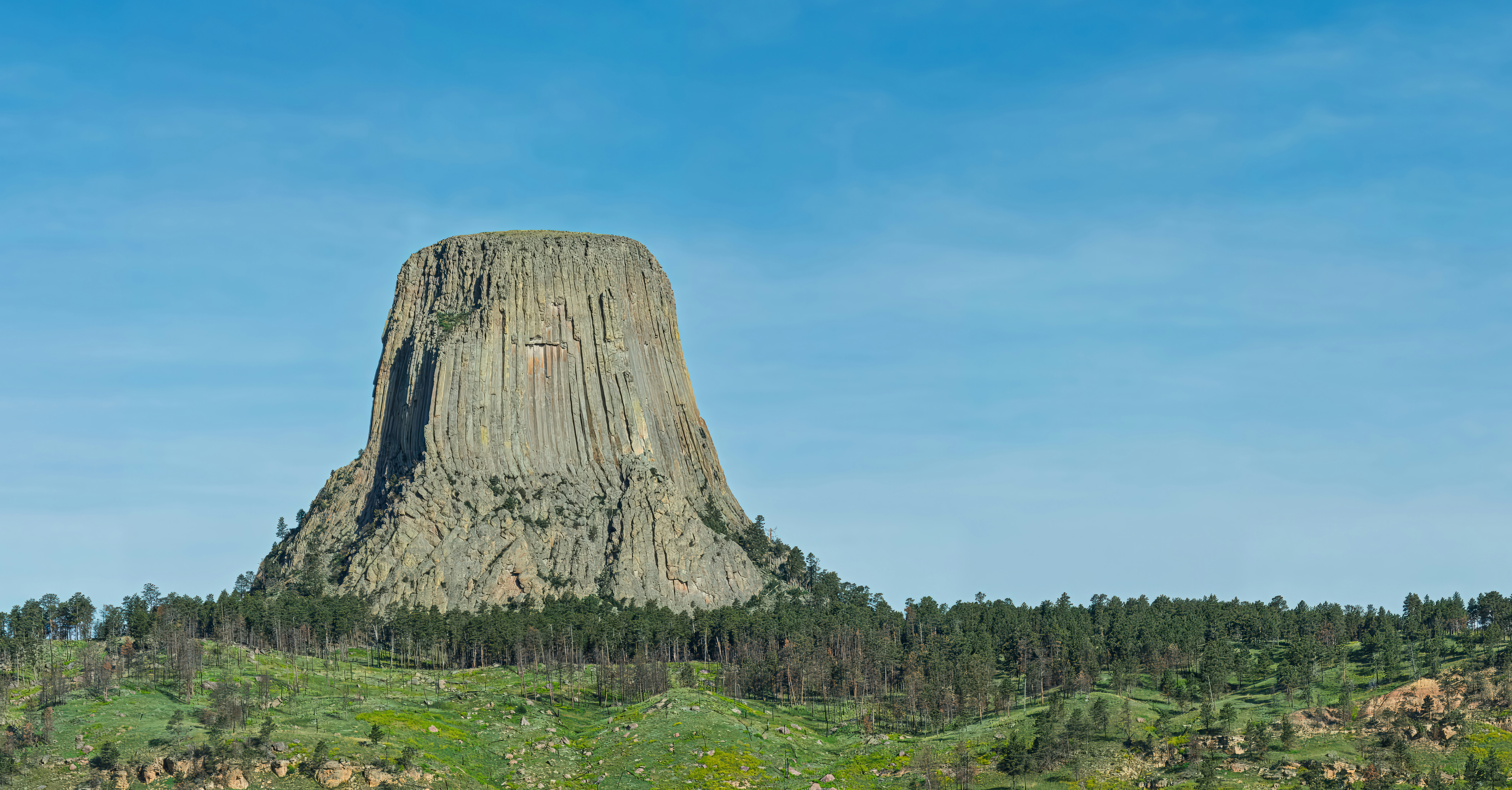 A large rock formation in the middle of a field