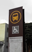 A brown sign with a yellow bus on it