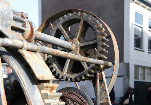 A close up of a metal object with a building in the background