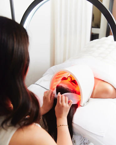 A woman in a white dress laying on a bed