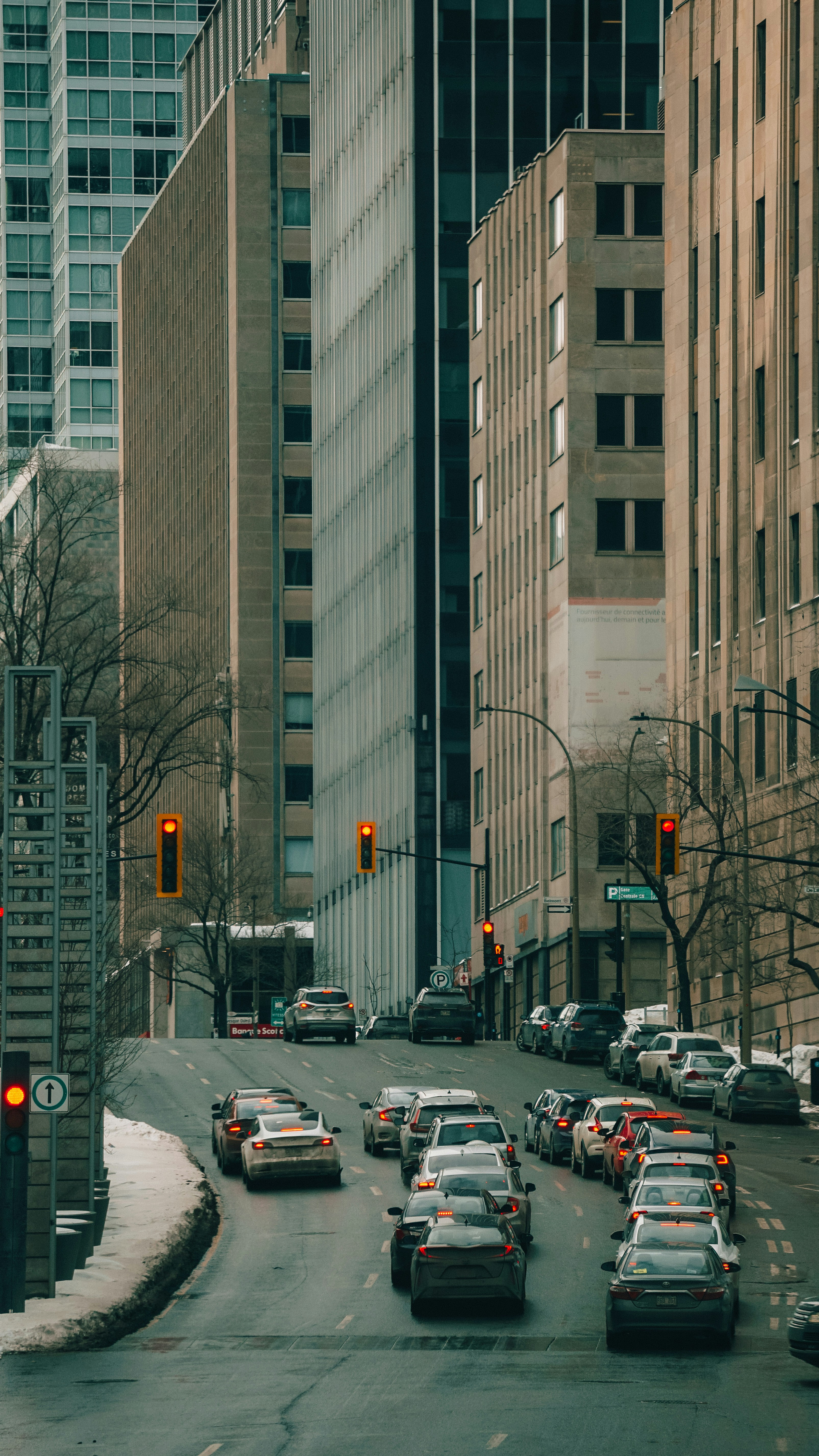 A street filled with lots of traffic next to tall buildings