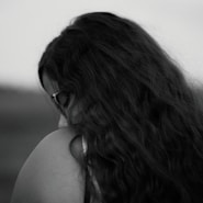 A black and white photo of a woman with long hair