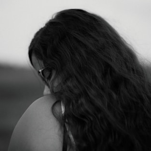 A black and white photo of a woman with long hair