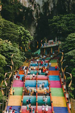 A group of people standing on top of a colorful staircase