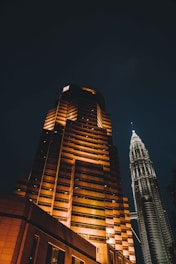 A tall building lit up at night in a city