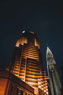 A tall building lit up at night in a city