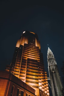 A tall building lit up at night in a city