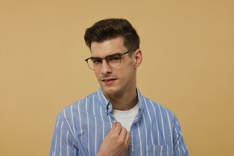 A man wearing glasses and a blue striped shirt