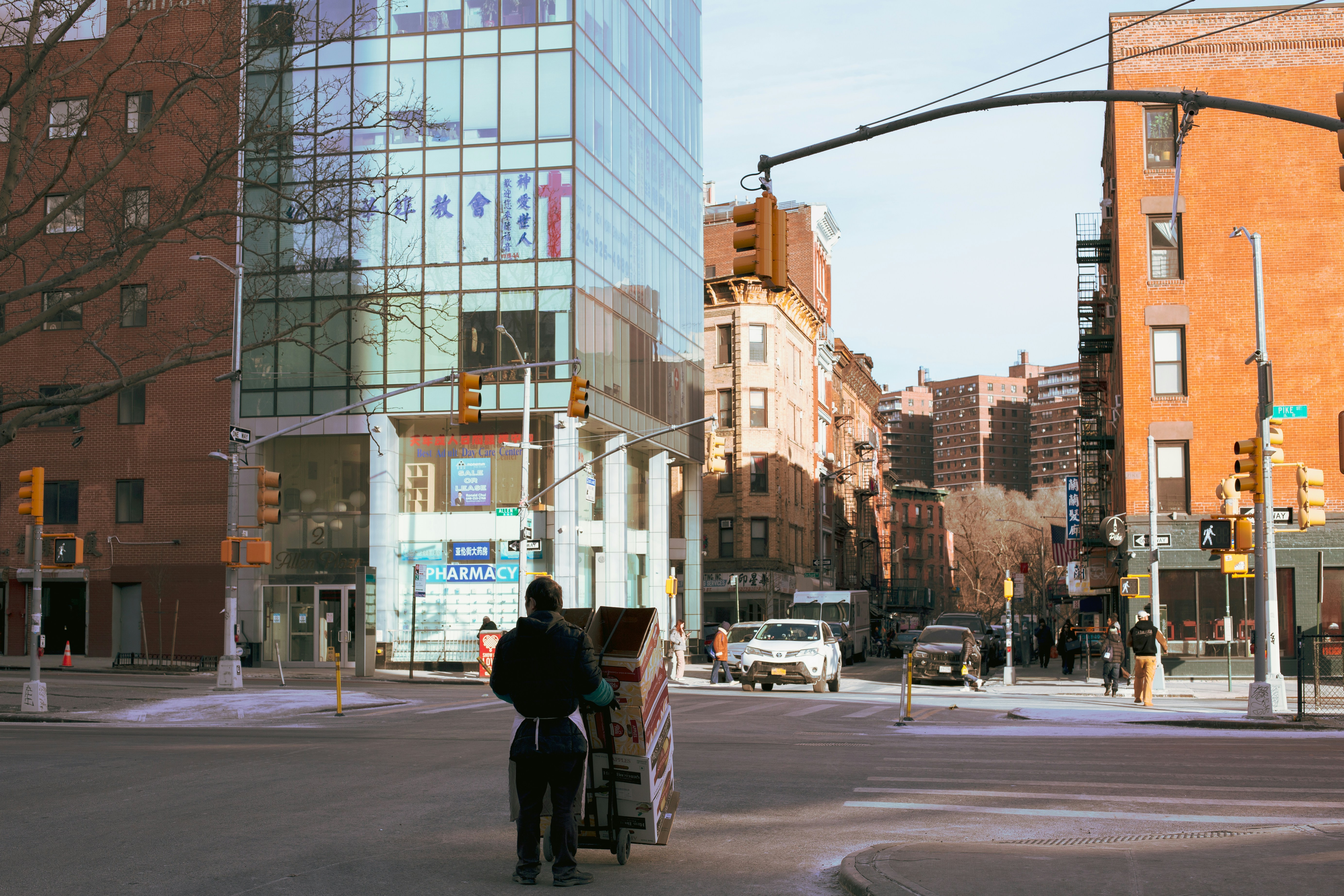 a-man-riding-a-bike-down-a-street-next-to-tall-buildings-photo-free