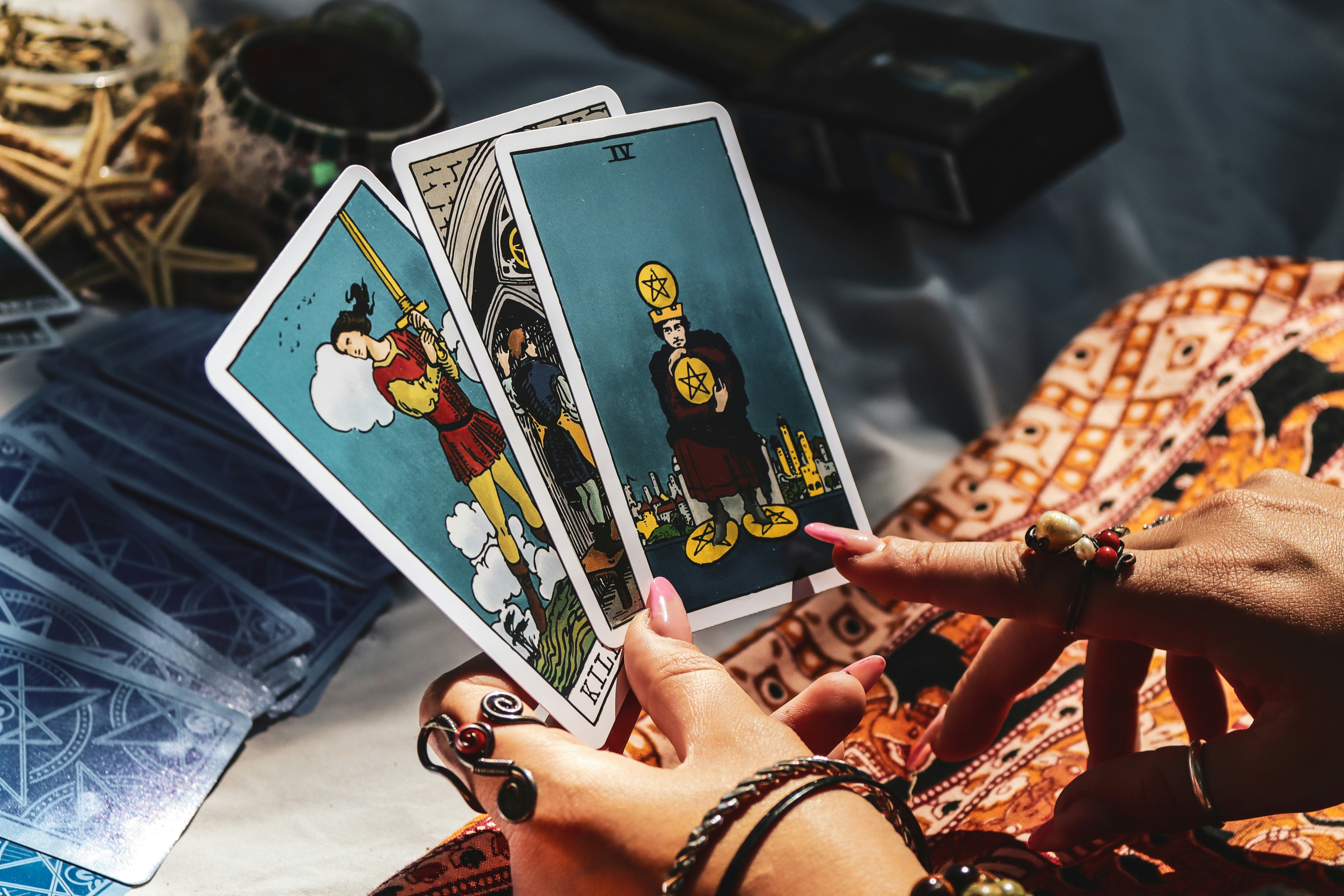 A person holding four cards in their hands