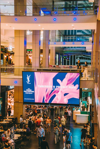 A group of people walking around a shopping mall