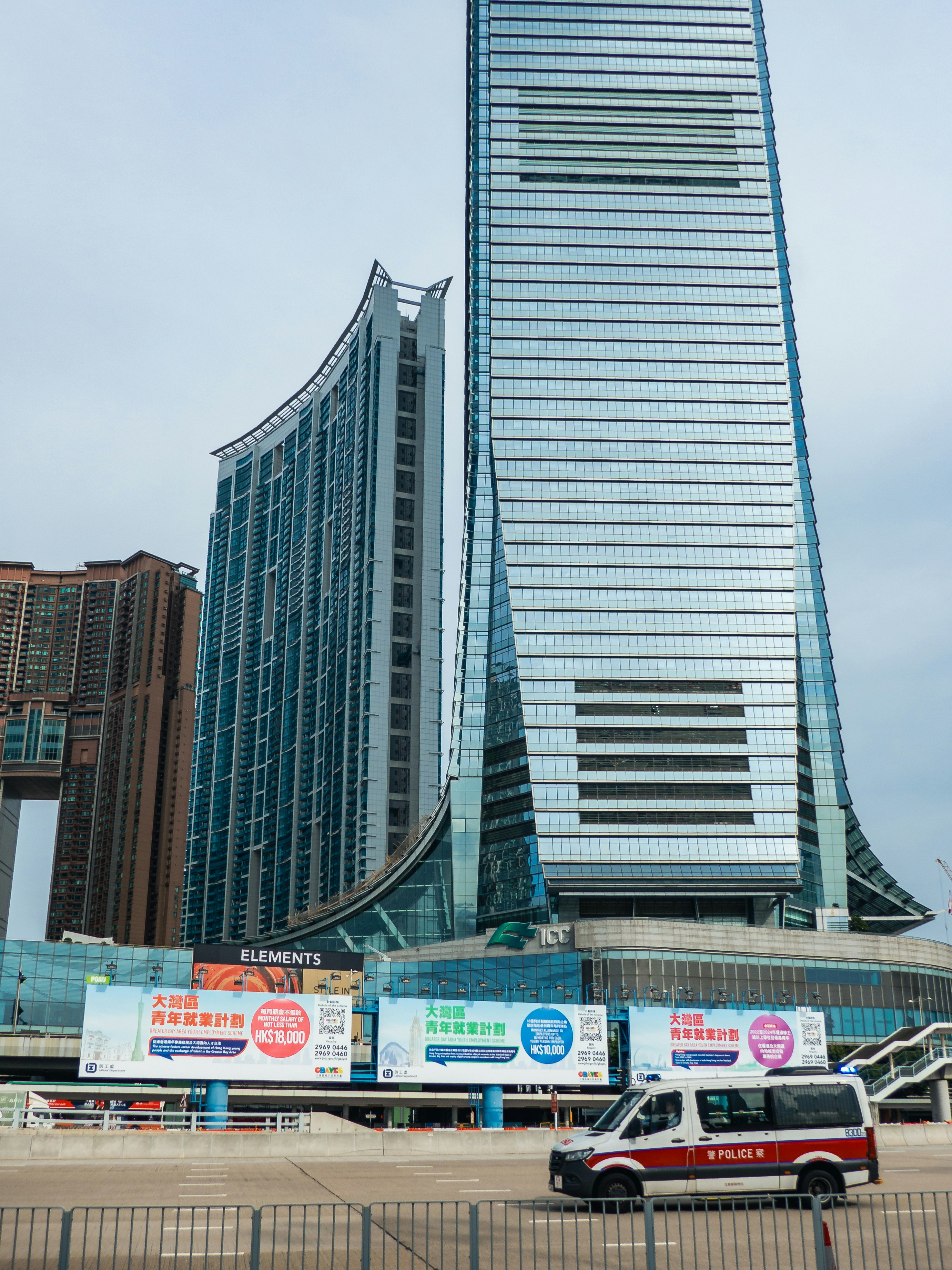 A van parked in front of a tall building