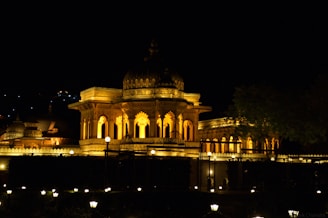 A large building lit up at night with lights on