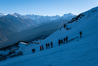 A group of people standing on top of a snow covered slope