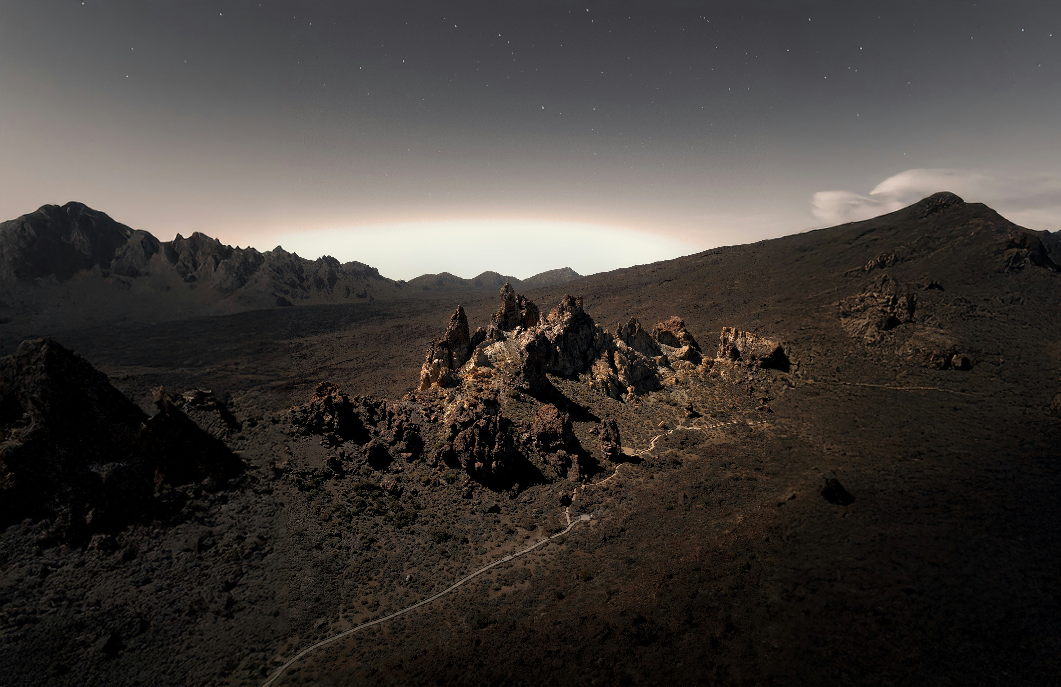 A view of a mountain with a sky background
