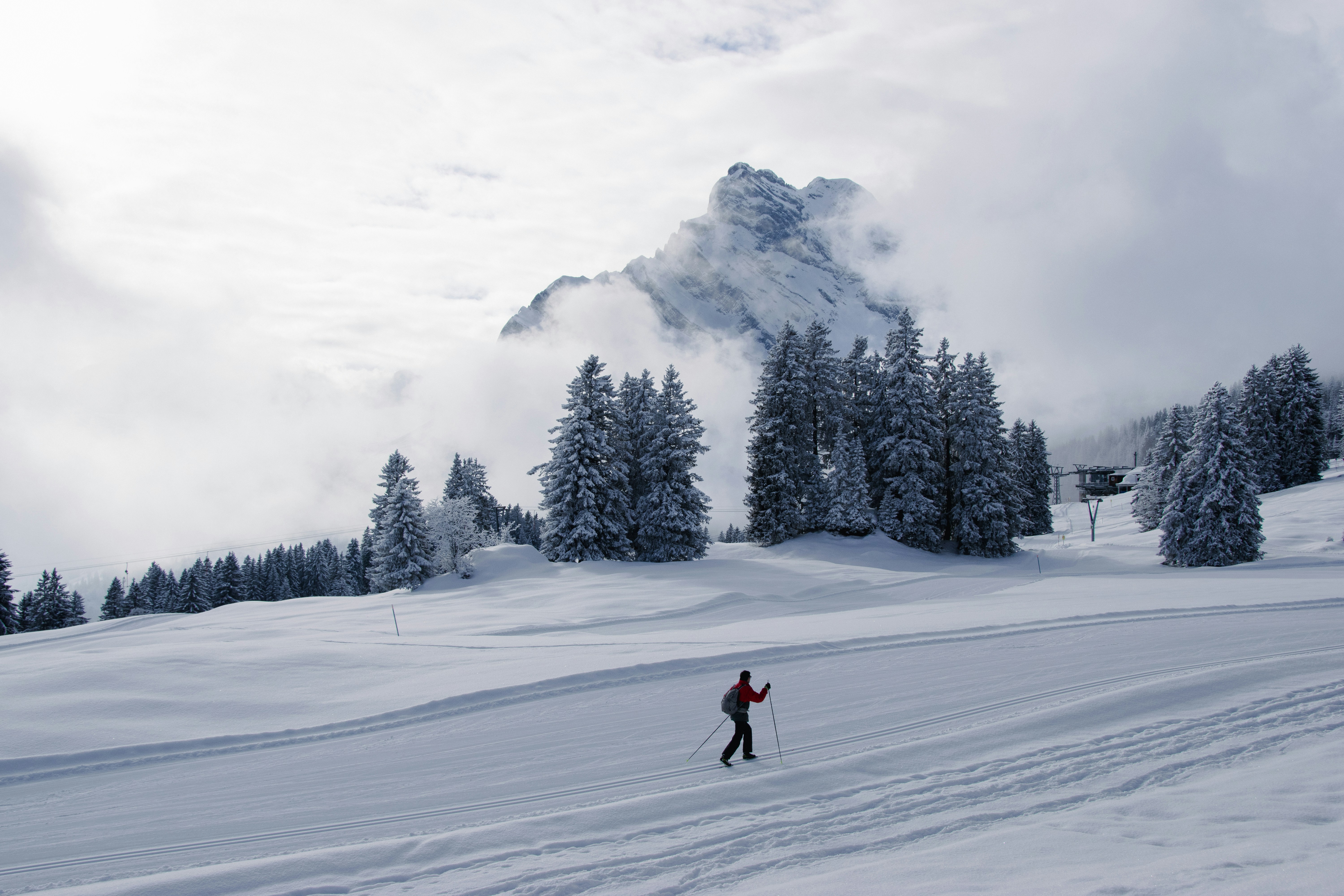 A person riding skis down a snow covered slope