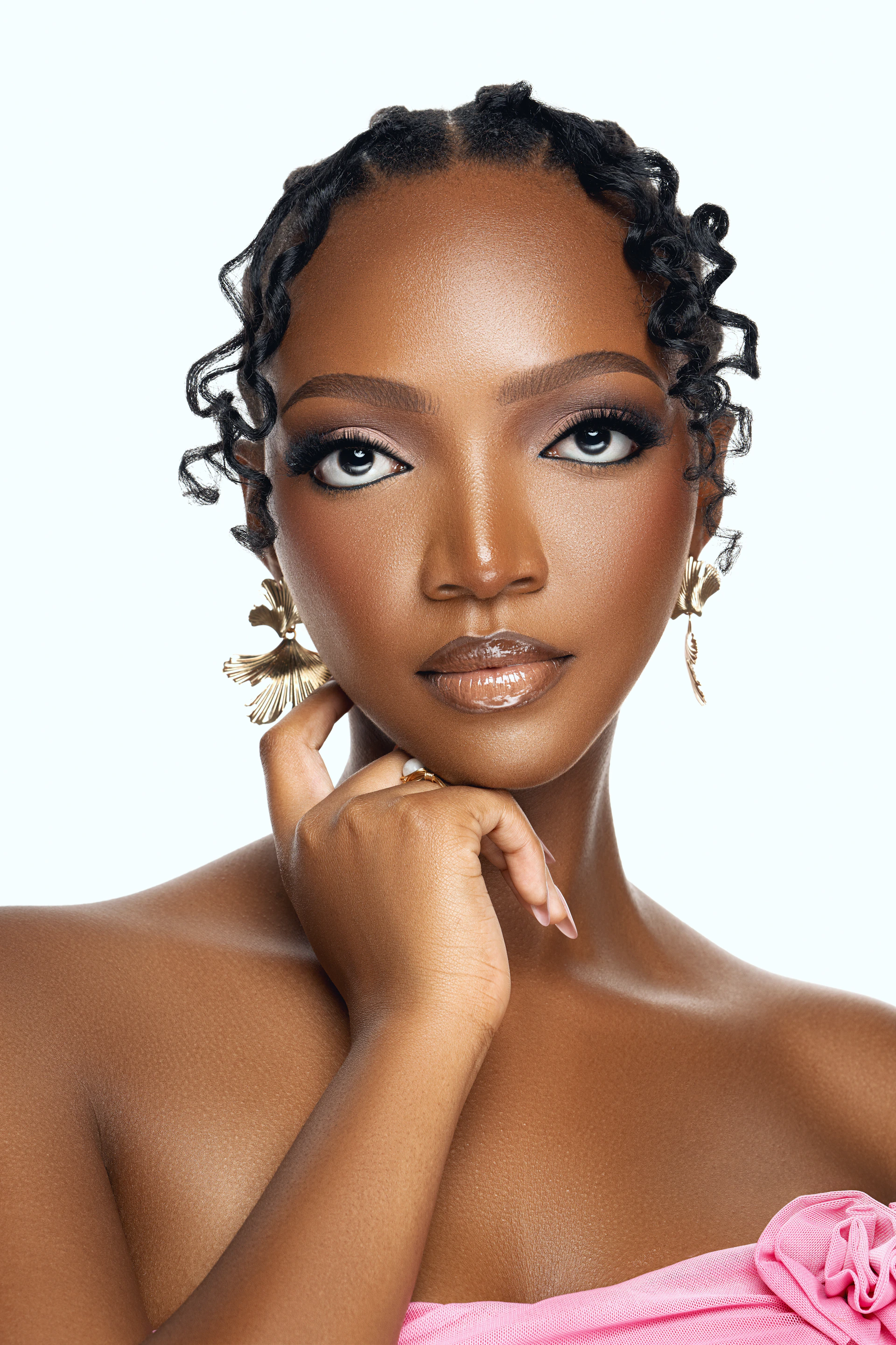 A woman in a pink dress posing for a picture