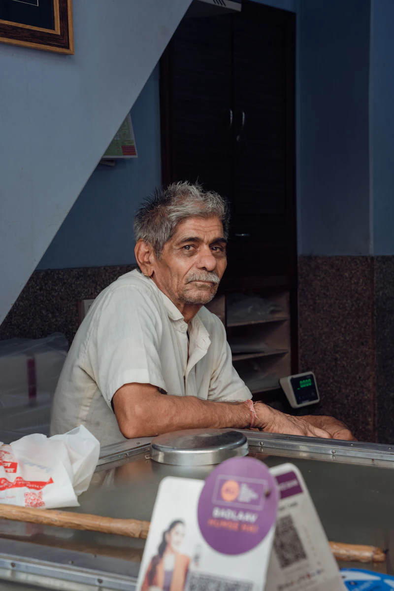 Shop owner at the counter of a small store