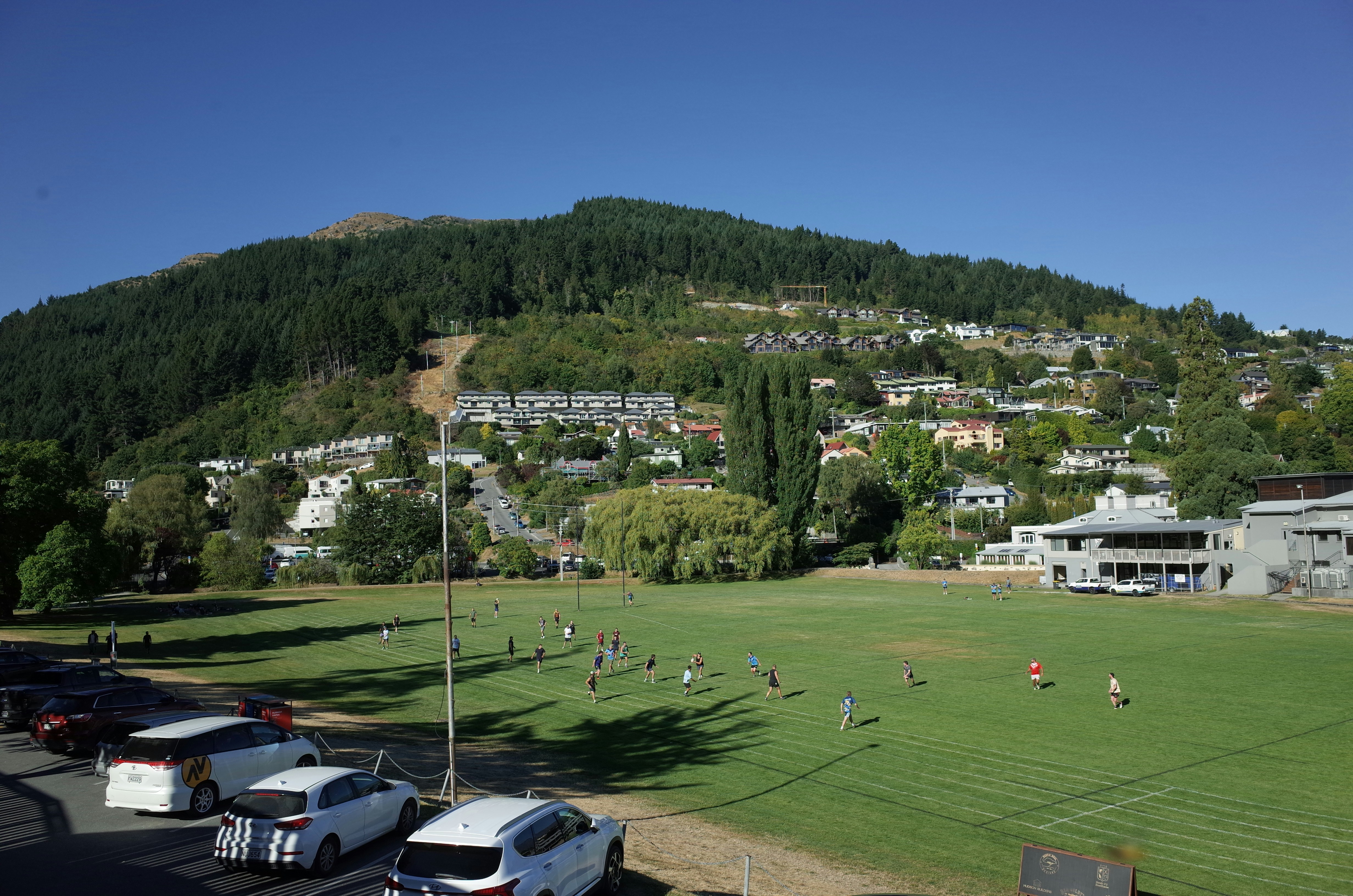 A soccer field with cars parked in it