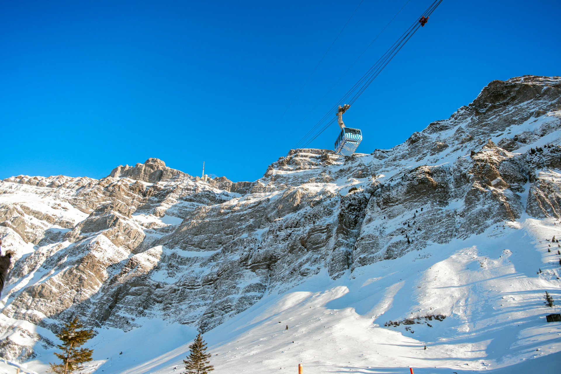 A man riding a snowboard down the side of a snow covered slope