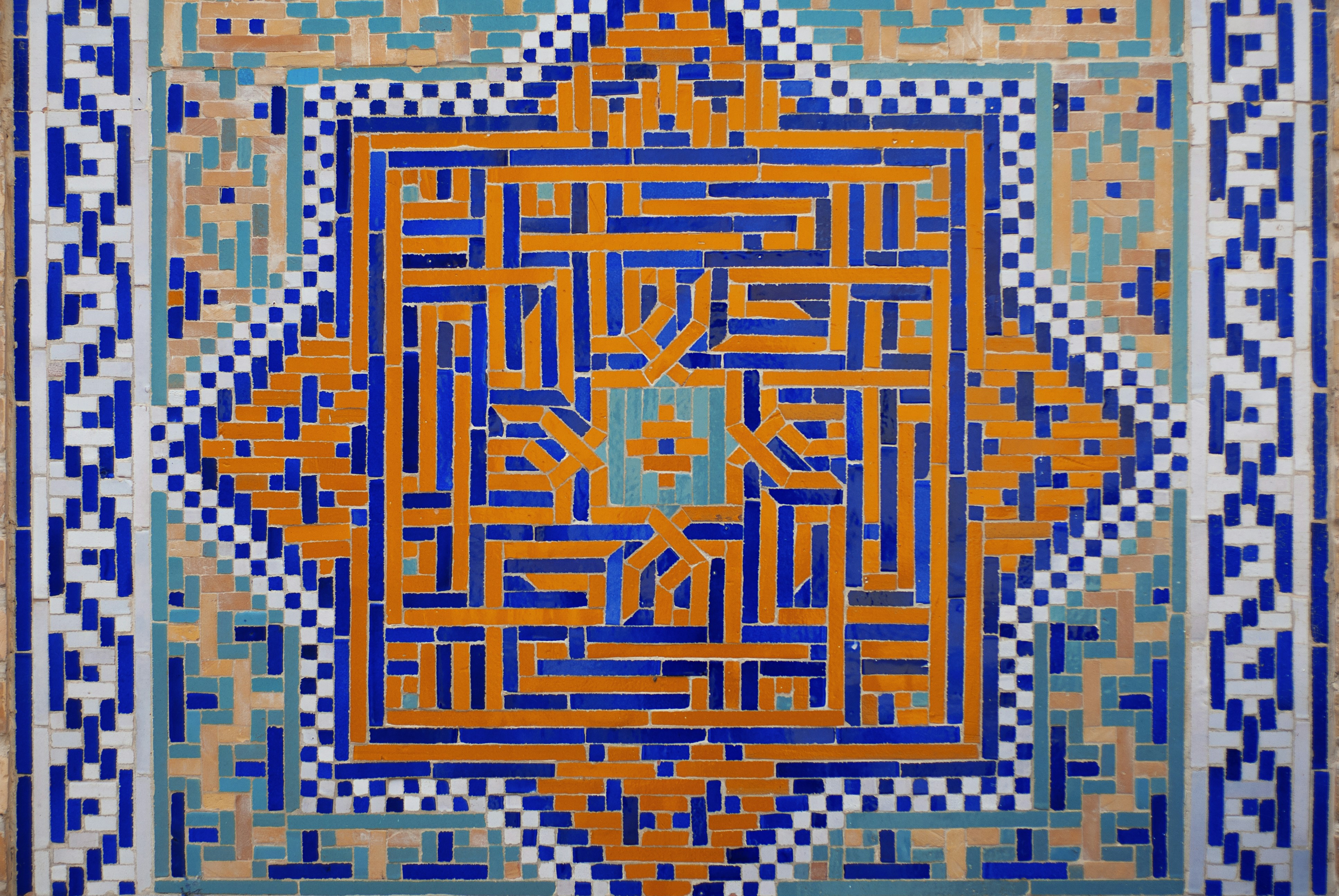 A painting of a blue and orange design on a wall