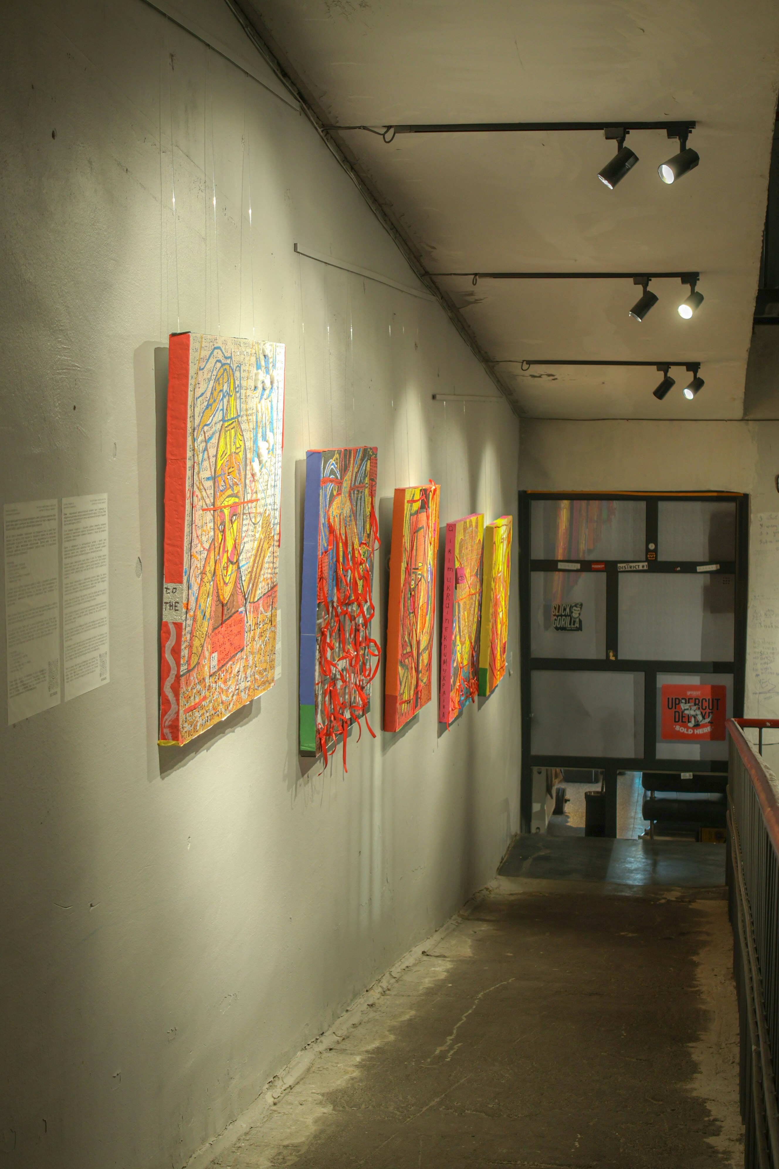 A long hallway with paintings on the wall