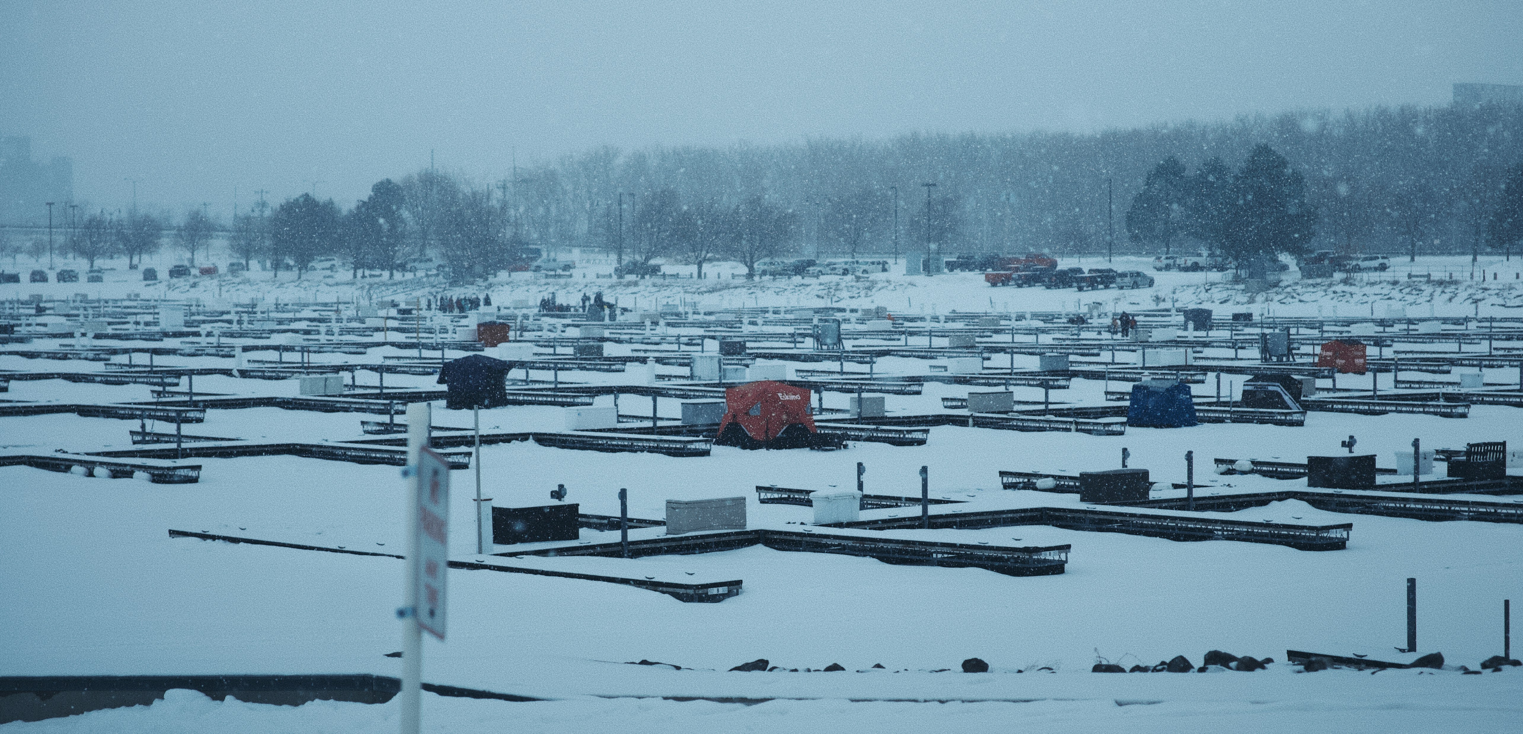 A snowy field filled with lots of tents